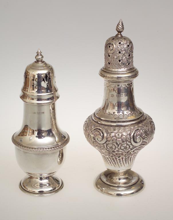 Appraisal: EDWARDIAN SILVER SUGAR CASTER BIRMINGHAM of characteristic form elaborately chased