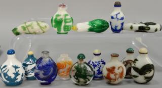 Appraisal: Fourteen overlay glass snuff bottles depicting deer dragons phoenix birds