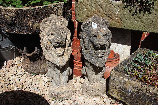 Appraisal: A PAIR OF COMPOSITE STONE LION STATUES each cm in