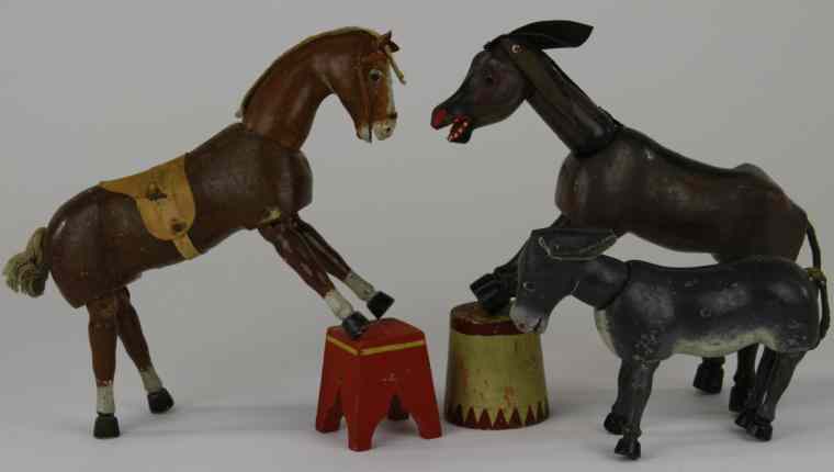 Appraisal: THREE GLASS EYED SCHOENHUT ANIMALS Includes donkey brown horse with