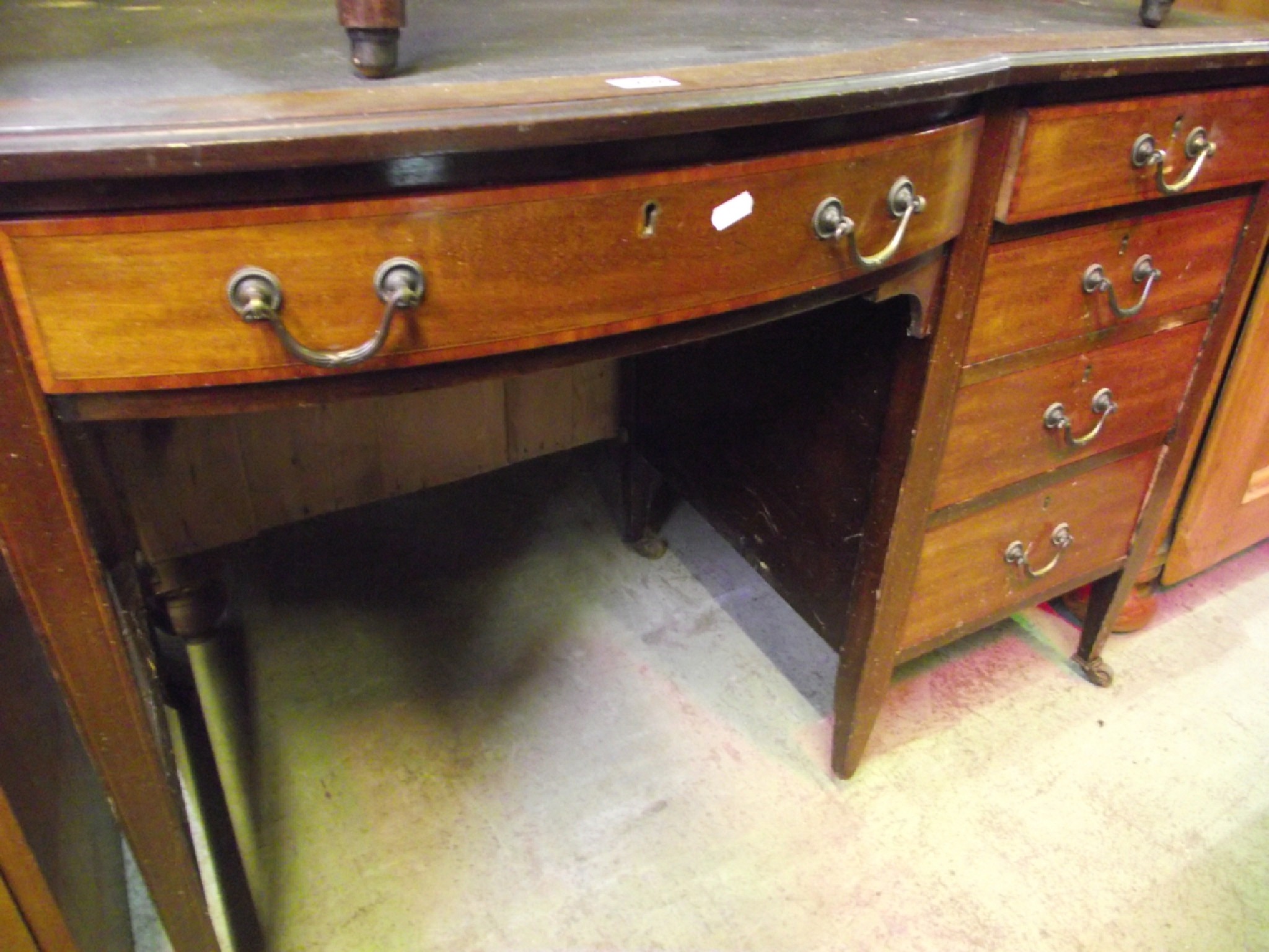 Appraisal: An inlaid Edwardian mahogany kneehole single pedestal writing desk with