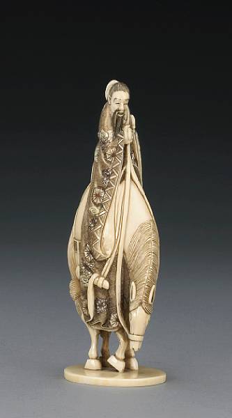 Appraisal: An ivory figural okimono Portraying a Chinese sage wearing elaborate