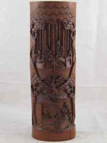 Appraisal: A Chinese bamboo brushpot deeply carved with domestic scenes cm