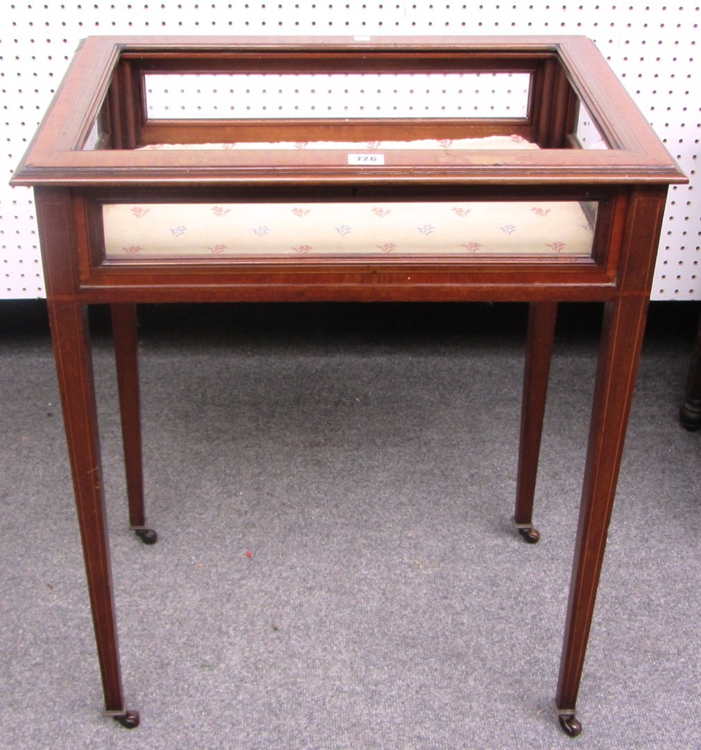 Appraisal: An Edwardian satinwood and mahogany rectangular vertu table on tapering