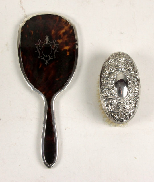 Appraisal: A oval silver backed hair brush Birmingham and a tortoiseshell