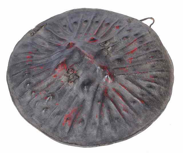 Appraisal: AN ETHIOPIAN HIDE SHIELD decorated with traces of red paint