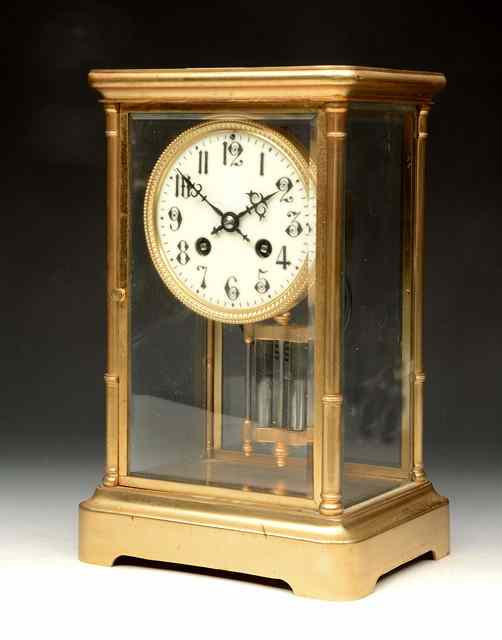 Appraisal: A FRENCH FOUR GLASS MANTEL CLOCK having a white enamel