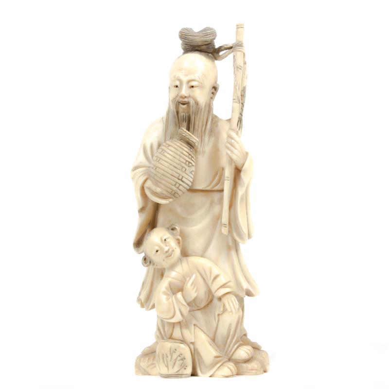 Appraisal: Chinese carved ivory figure group Elder with child and fish