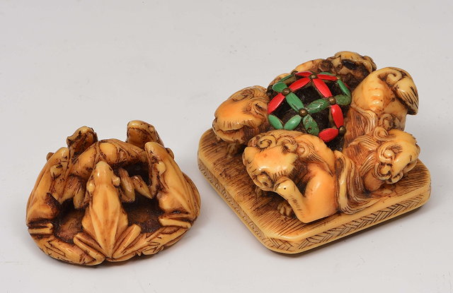 Appraisal: A Japanese ivory netsuke and a Japanese ivory group th