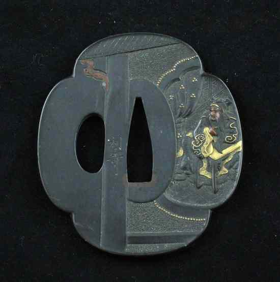 Appraisal: A Meiji period bronze tsuba overlaid with gold and copper