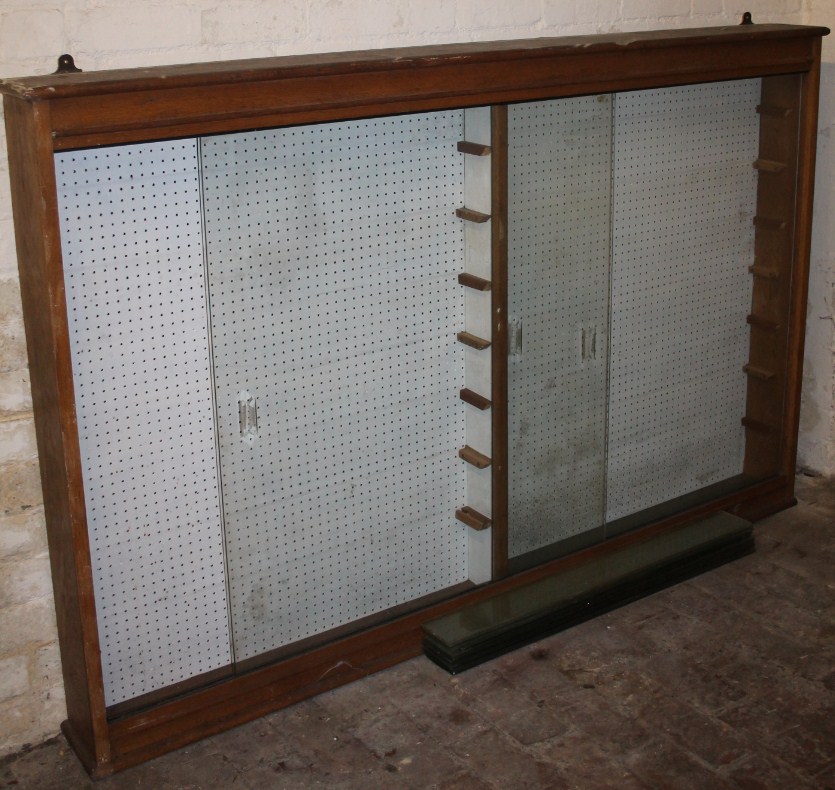 Appraisal: An early thC light oak hanging display cabinet with glazed