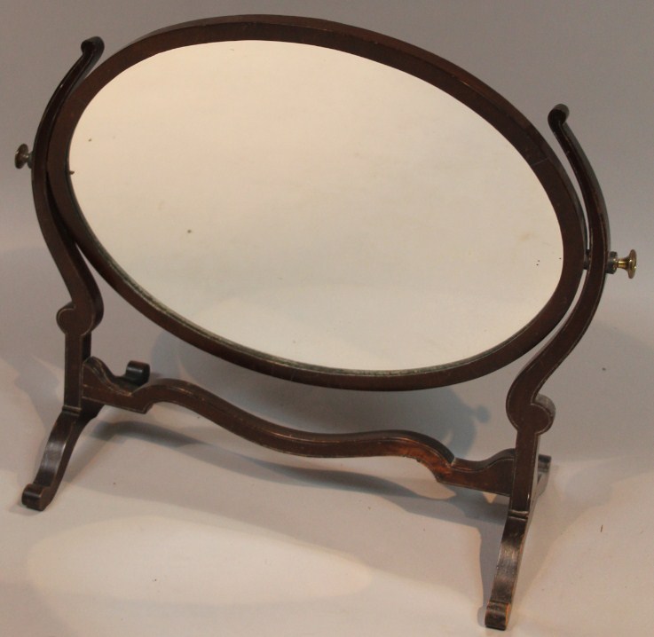 Appraisal: A thC table mirror the oval glass flanked by scroll