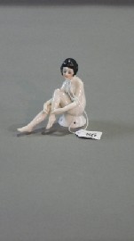 Appraisal: A German porcelain Art Deco seated nude flapper with moulded