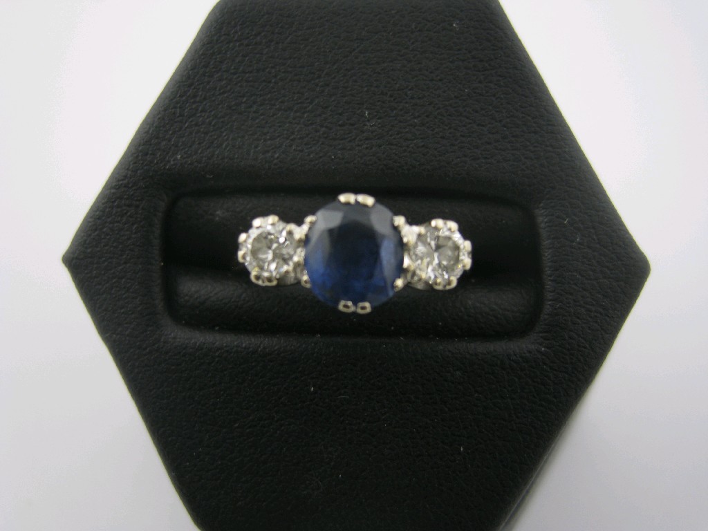 Appraisal: A Sapphire and Diamond three stone Ring the central oval-cut