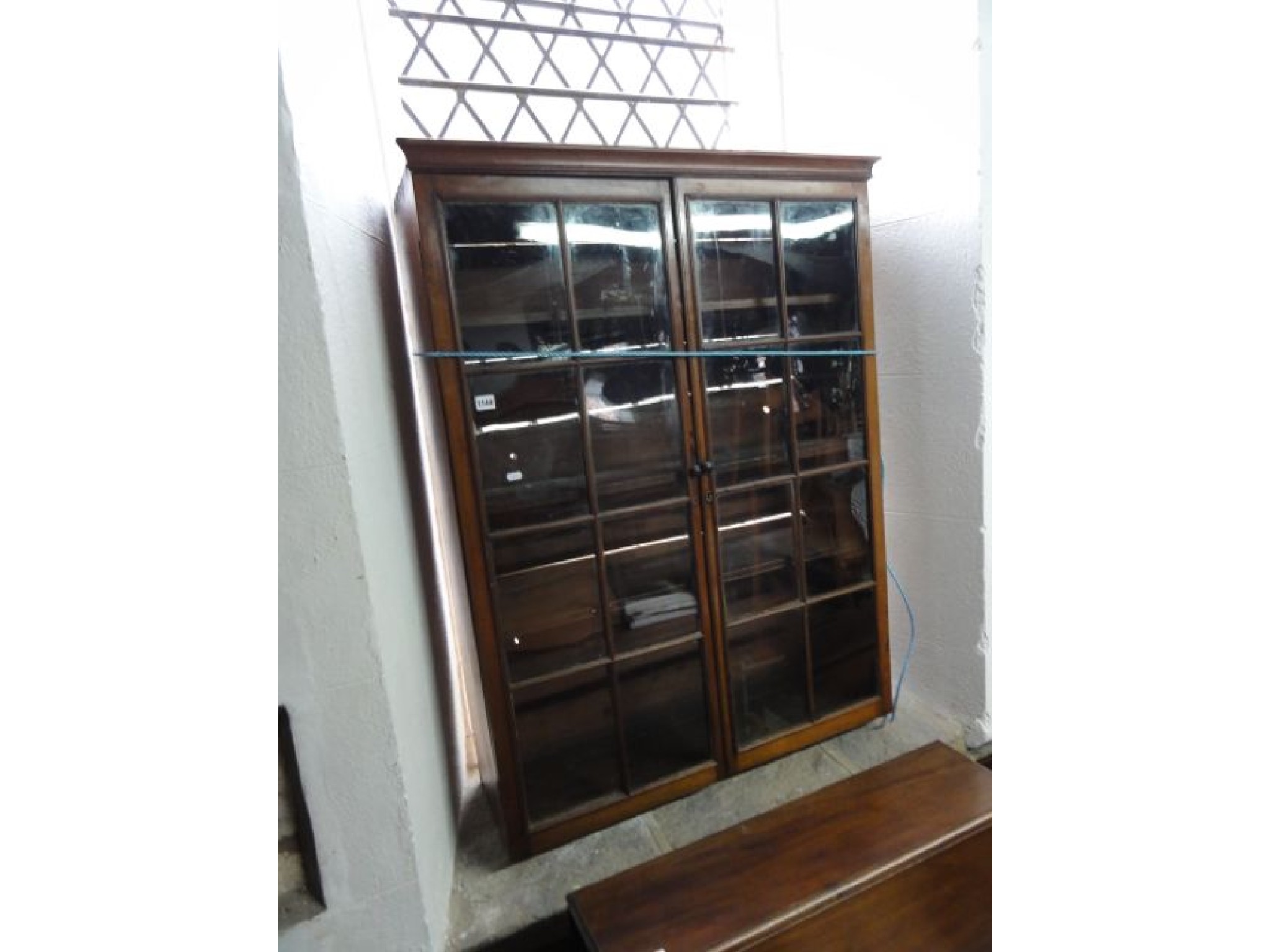 Appraisal: A Georgian mahogany bookcase enclosed by a pair of rectangular