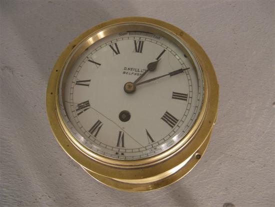 Appraisal: Early twentieth century Irish brass cased ships clockenamelled dial inscribed