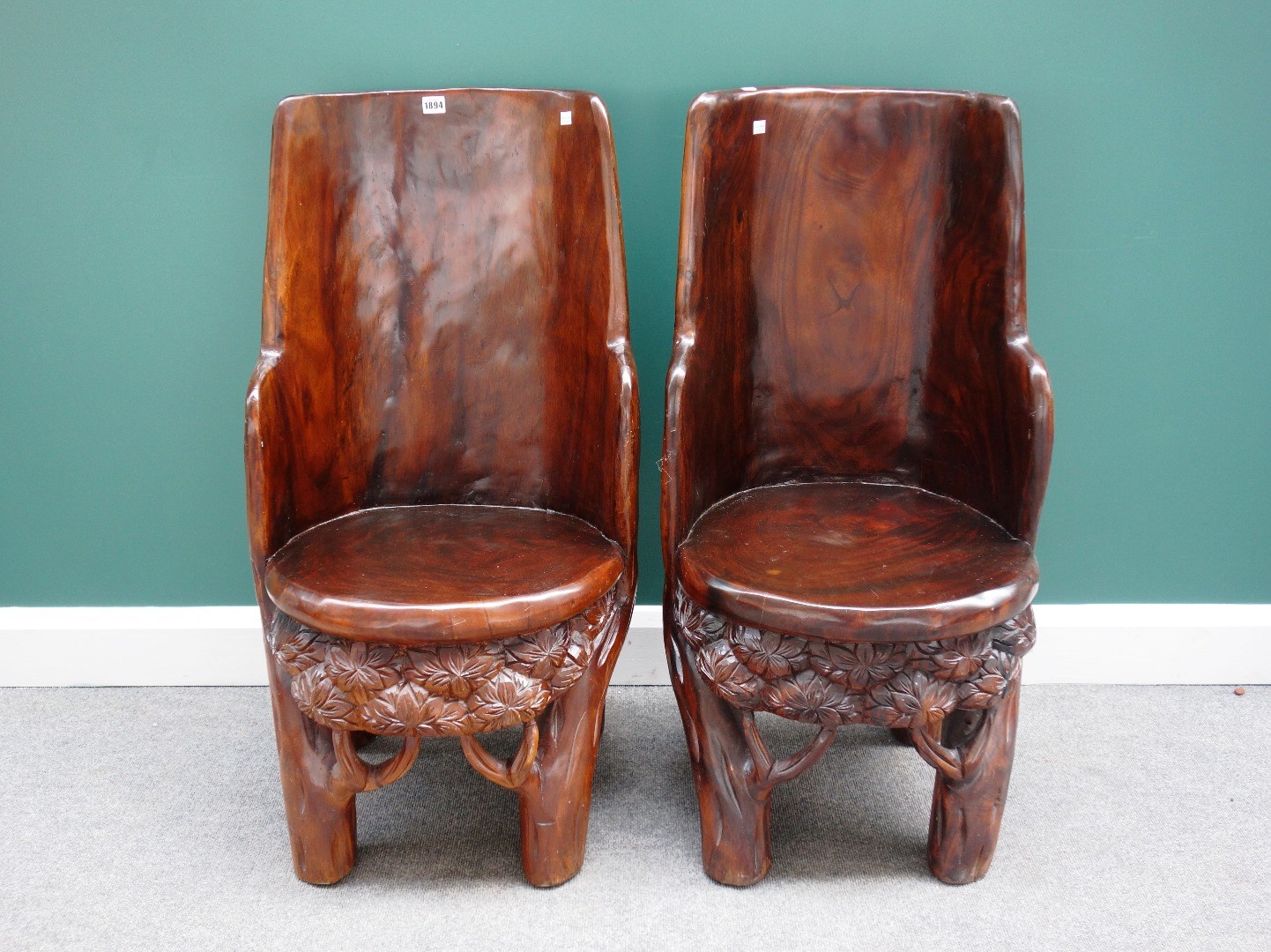 Appraisal: A pair of th century Eastern carved hardwood trunk chairs