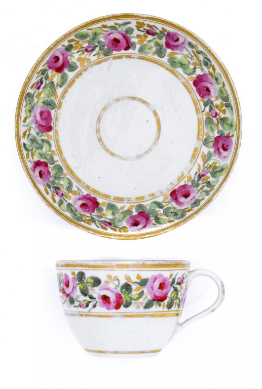 Appraisal: A PINXTON TEACUP AND SAUCER attractively painted with a wide