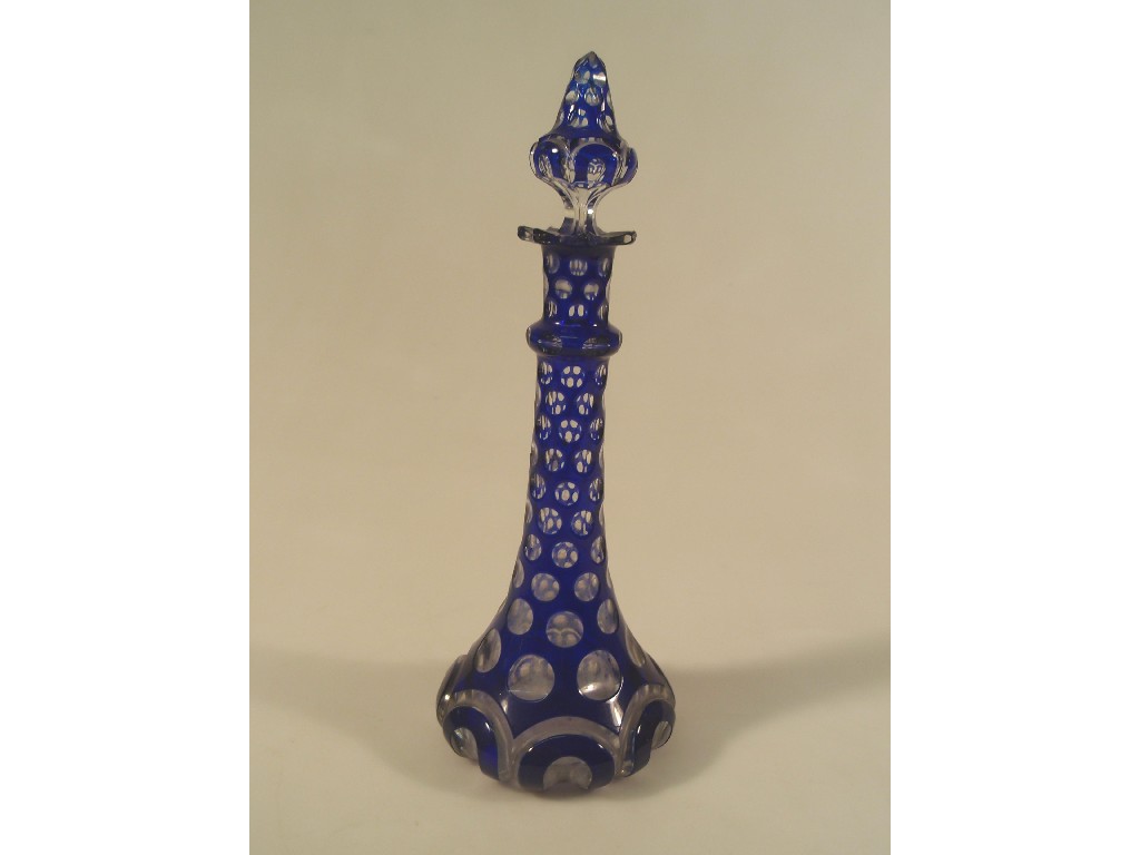 Appraisal: A Bohemian blue cased glass decanter with a baluster stopper