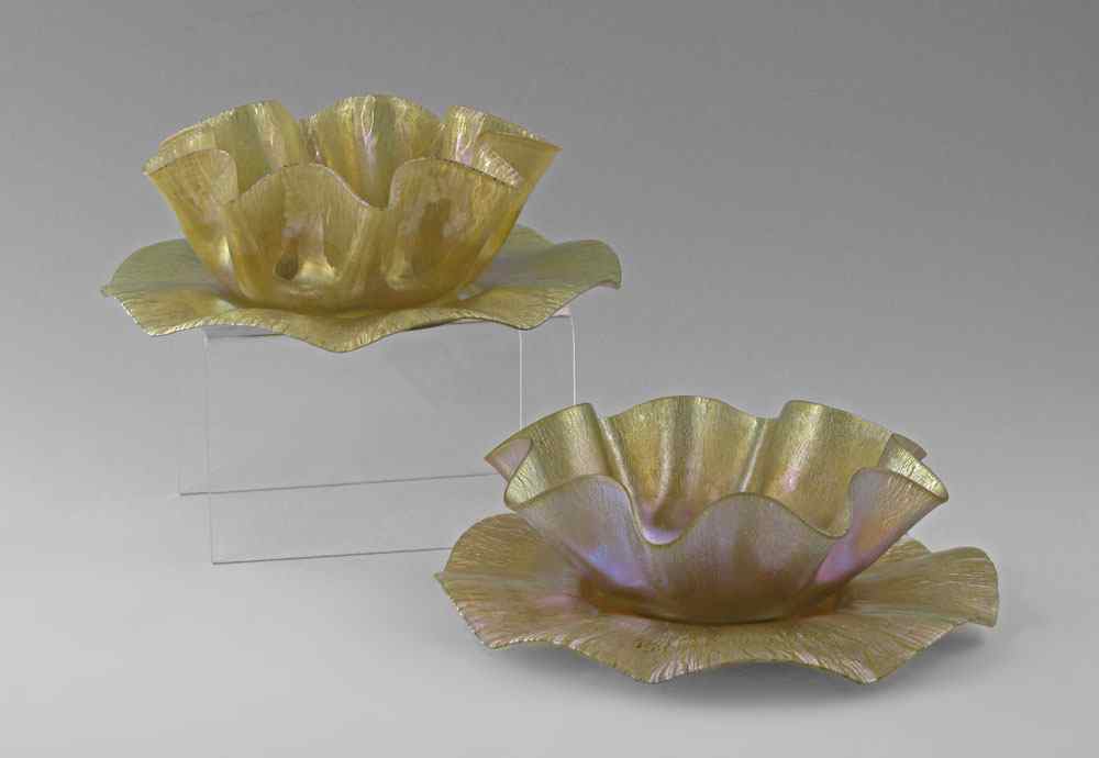 Appraisal: TIFFANY FAVRILE GLASS BOWLS AND UNDERPLATES Scalloped rim bowls and