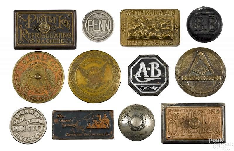 Appraisal: Twelve cast iron advertising paperweights Twelve cast iron advertising paperweights