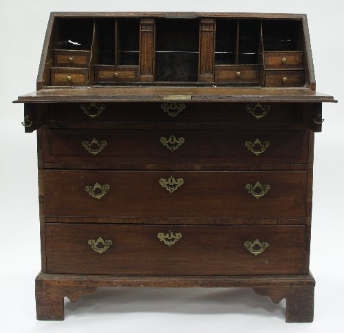 Appraisal: An th Century oak bureau with fitted interior of drawers