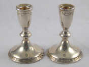 Appraisal: A pair of weighted silver candlesticks ht cm marked Empire