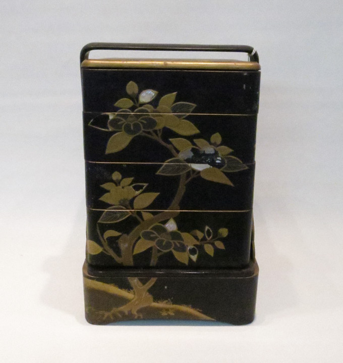 Appraisal: JAPANESE BLACK LACQUER STACKING LUNCH BOX decorated with mother of