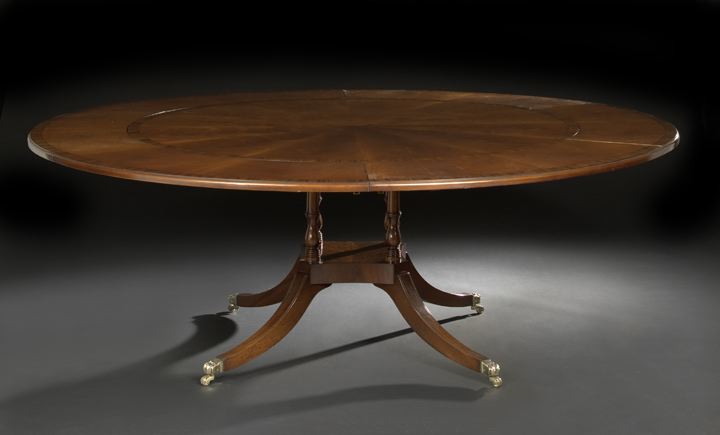 Appraisal: Regency-Style Mahogany Dining Table the circular banded top with horseshoe