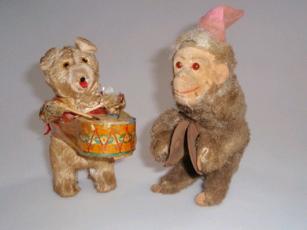 Appraisal: A clockwork monkey with cymbals cm and a bear drummer