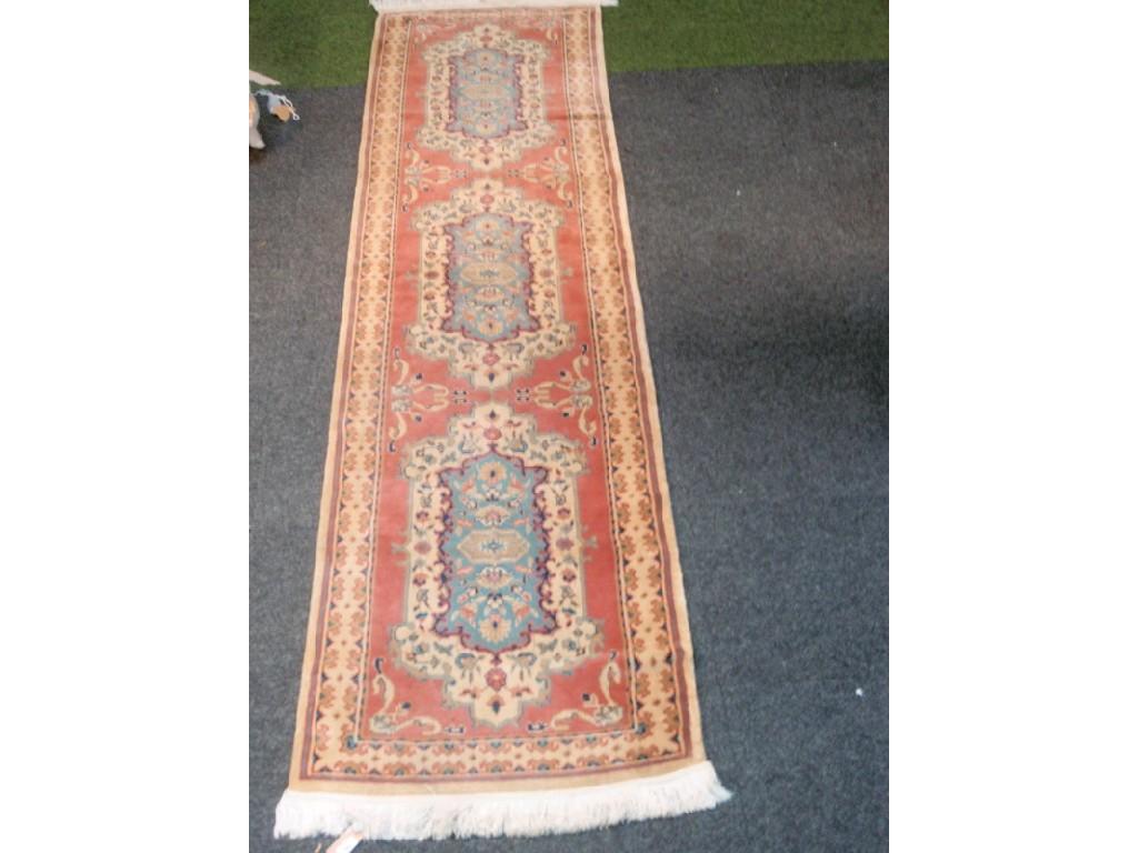 Appraisal: A Persian rug peach and cream ground with three blue