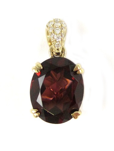 Appraisal: GARNET DIAMOND AND FOURTEEN KARAT GOLD PENDANT with round-cut diamonds