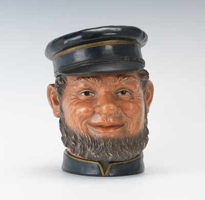 Appraisal: A Stylized Tobacco Jar Head of Man with Cap and