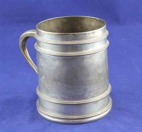 Appraisal: An Edwardian silver mug of restrained tapering form with banded