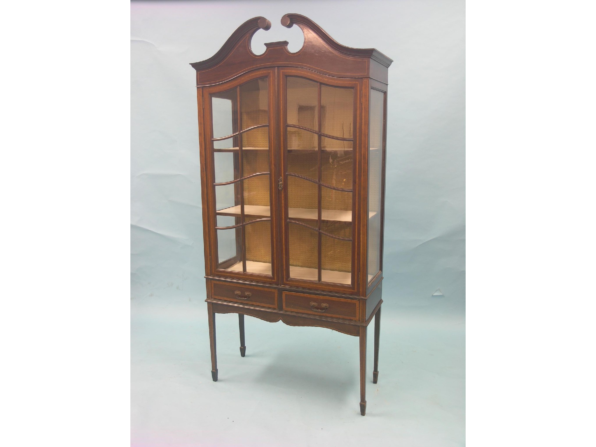 Appraisal: An Edwardian inlaid mahogany display cabinet swan-neck pediment above pair