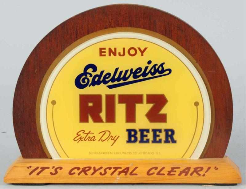 Appraisal: Edelweiss Ritz Beer Reverse Glass Sign On wooden base and