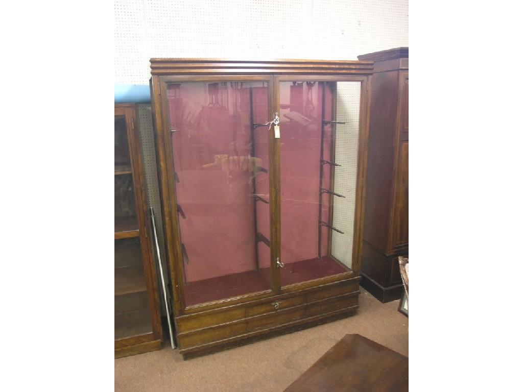 Appraisal: A large dark beech display cabinet pair of doors enclosing