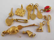 Appraisal: A collection of yellow metal tests carat gold charms including