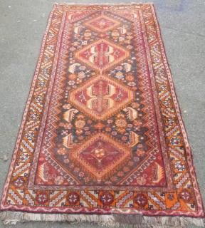 Appraisal: Persian red ground rug with four lozenge shaped medallions cm