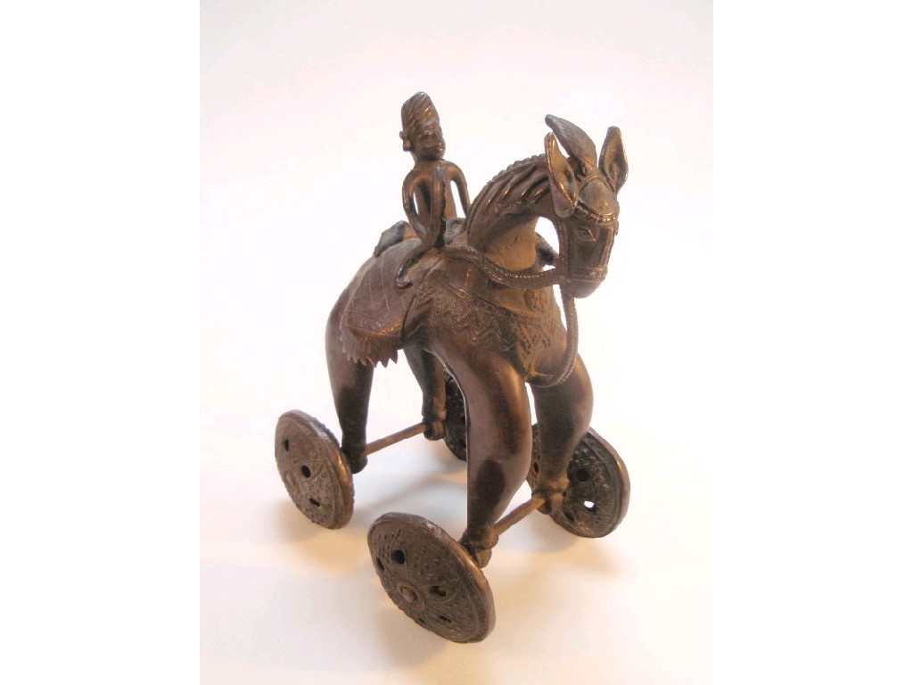 Appraisal: An Indian bronze toy cast as a boy on horse