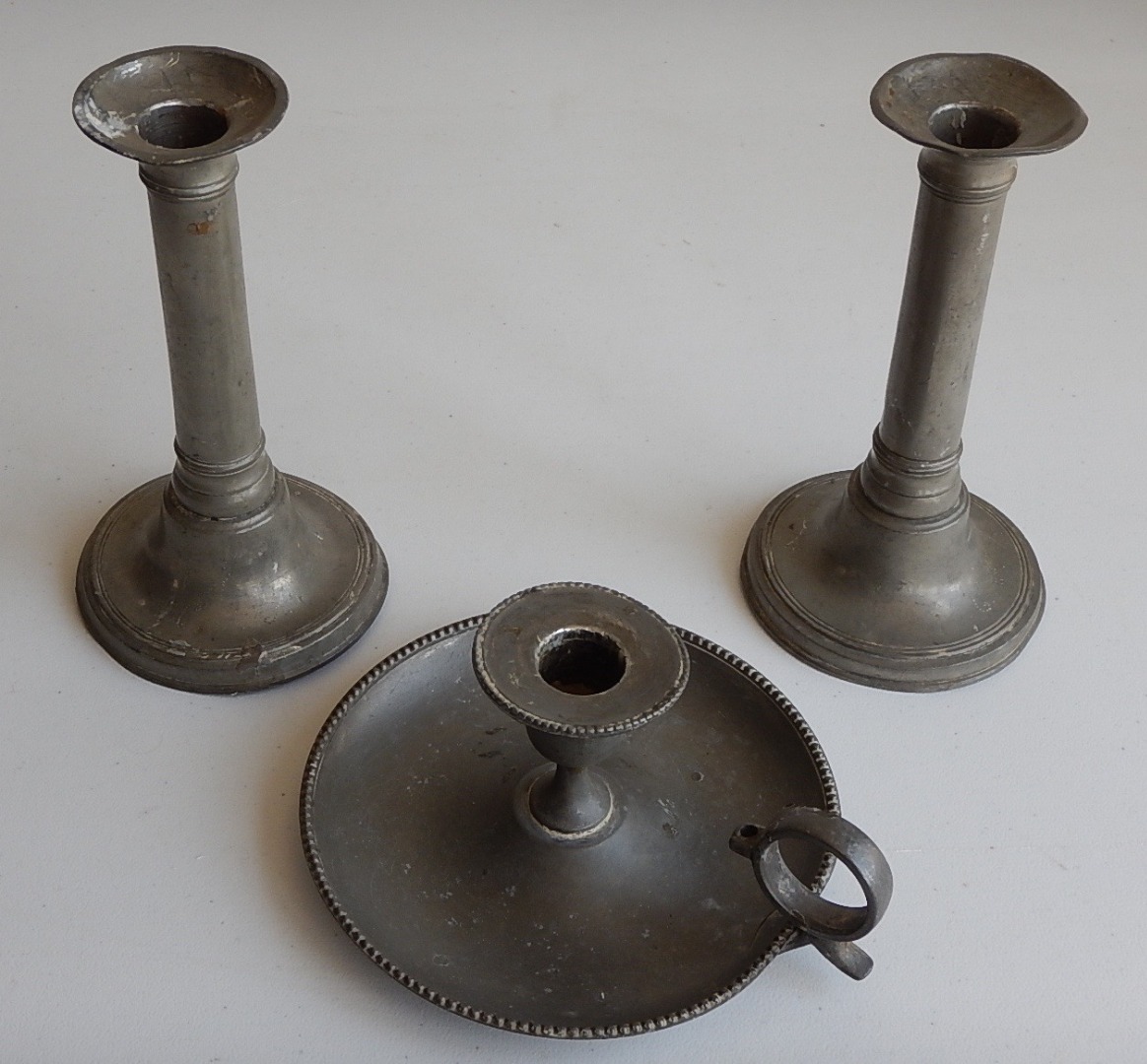 Appraisal: A pair of thC plain pewter candlesticks with cannon barrel