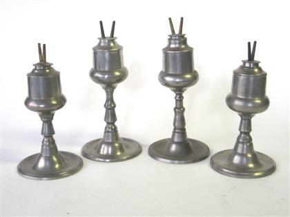 Appraisal: Four tall pewter camphene lamps capen molineux new york Including