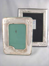 Appraisal: Two white metal faced strut back photo frames one Greek