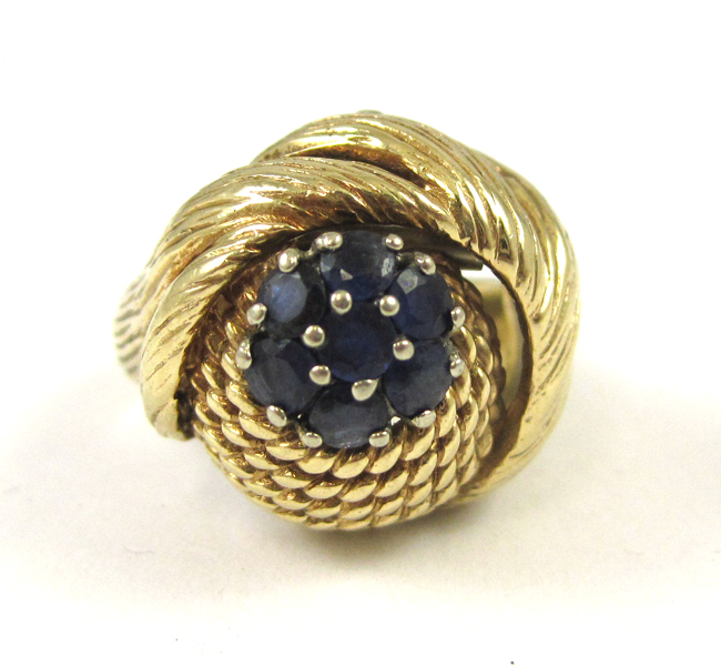 Appraisal: SAPPHIRE AND FOURTEEN KARAT GOLD RING set with seven round-cut