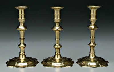 Appraisal: Three petal base brass candlesticks petal bases below baluster posts