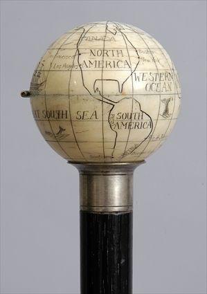 Appraisal: IVORY-HANDLED EBONIZED WOOD CANE Modeled as a terrestrial globe with