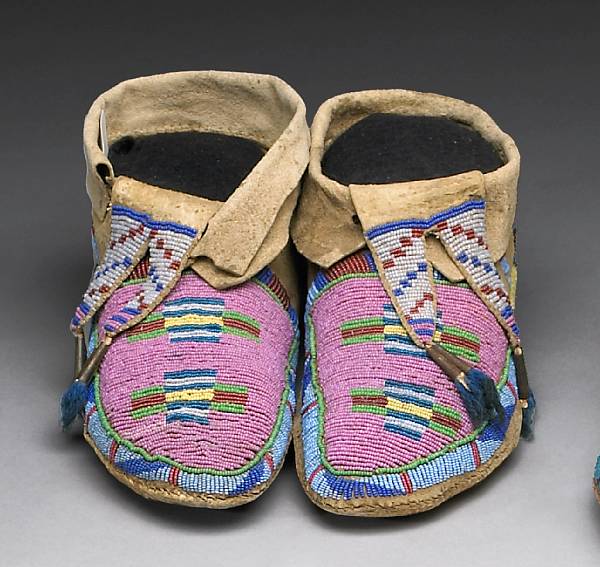 Appraisal: A pair of Crow beaded moccasins With stiff soles and