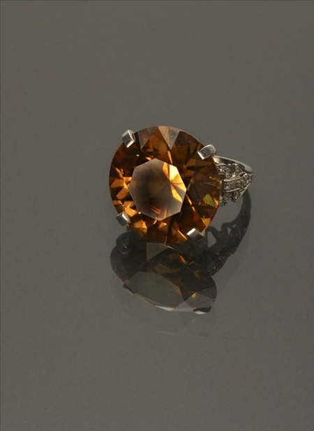 Appraisal: Tested Platinum Orange-Brown Zircon and Diamond Dinner Ring The four-prong