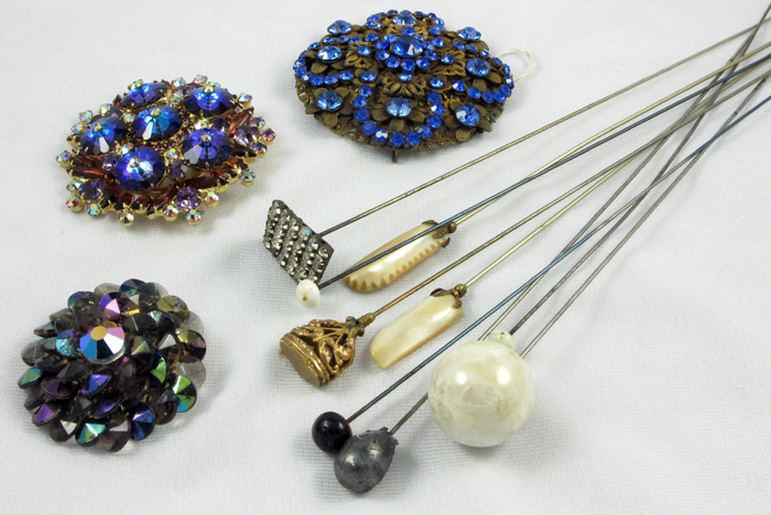 Appraisal: A COLLECTION OF NINE EARLY HATPINS AND THREE COSTUME BROACHES