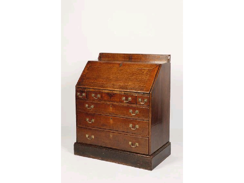 Appraisal: A GEORGE III OAK BUREAU the sloping fall enclosing a